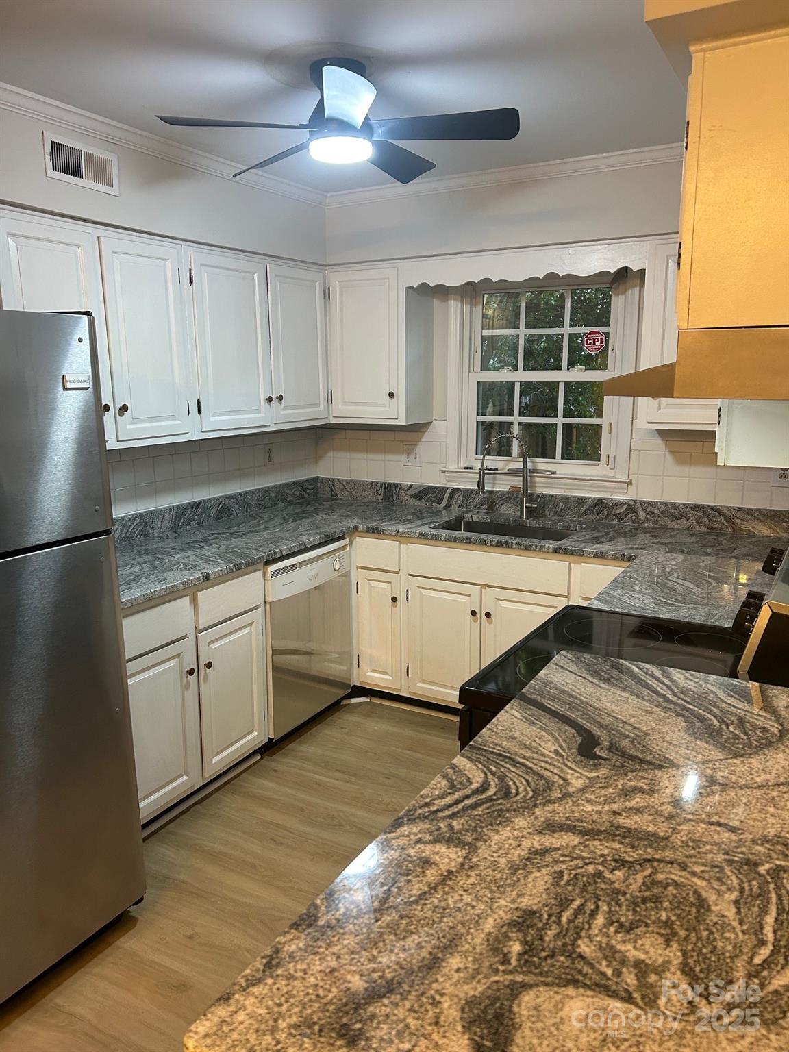 2227 Rexford Road Charlotte, NC 28211 - Photo 13 of 31 a kitchen with granite countertop white cabinets and white appliances