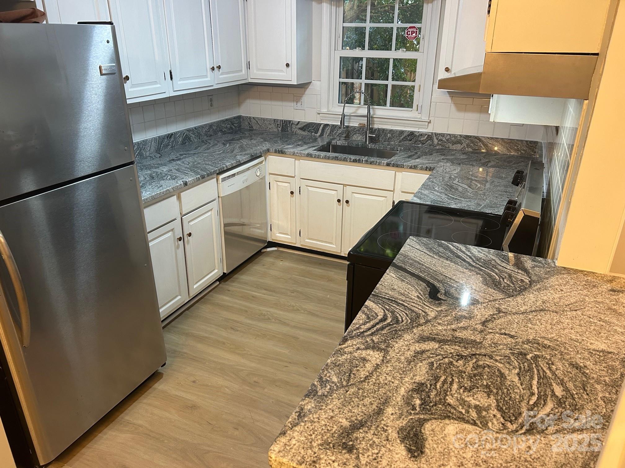 2227 Rexford Road Charlotte, NC 28211 - Photo 15 of 31 a kitchen with granite countertop a sink and a refrigerator