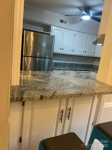 a kitchen with a refrigerator and cabinets
