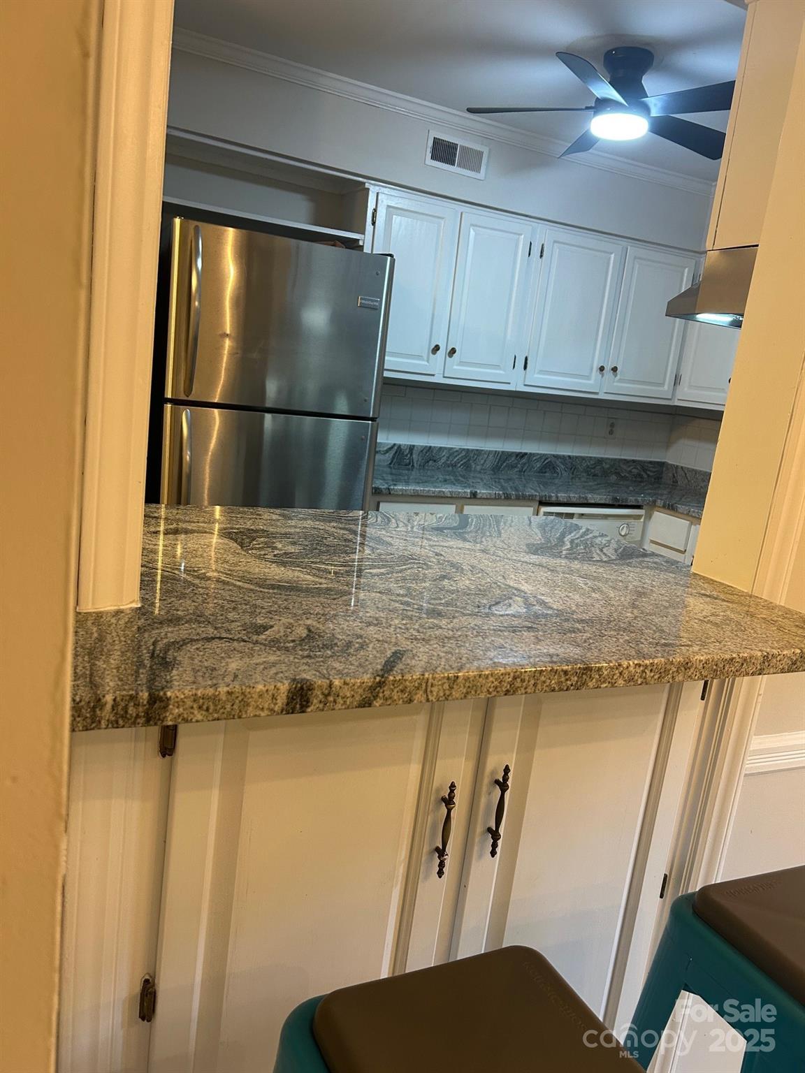 2227 Rexford Road Charlotte, NC 28211 - Photo 19 of 31 a kitchen with a refrigerator and cabinets
