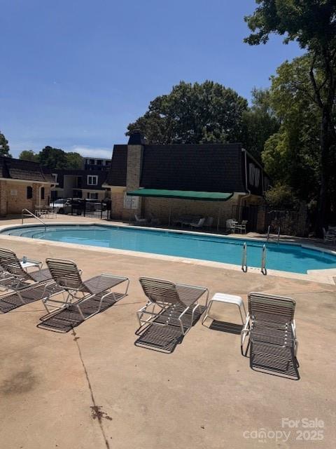 2227 Rexford Road Charlotte, NC 28211 - Photo 28 of 31 a swimming pool with outdoor seating and plants