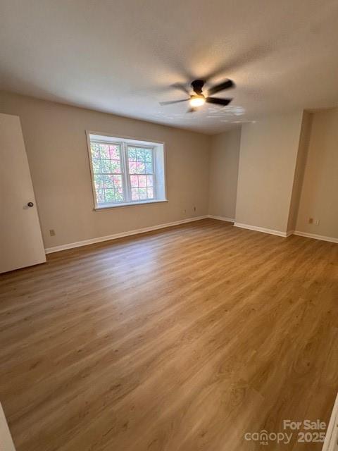 2227 Rexford Road Charlotte, NC 28211 - Photo 8 of 31 a view of an empty room with wooden floor and a window