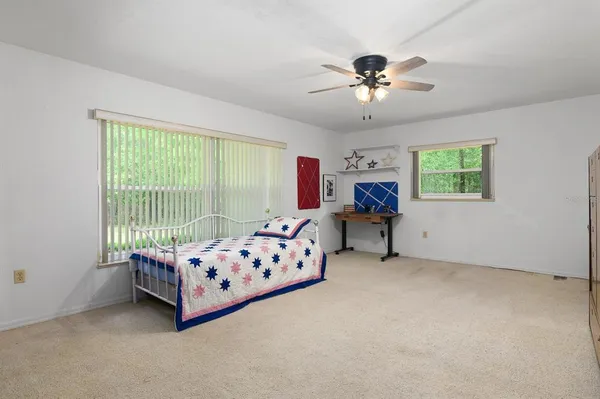 a bedroom with furniture and windows