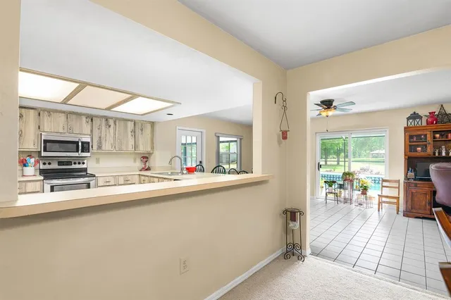 a kitchen with stainless steel appliances a sink and a refrigerator