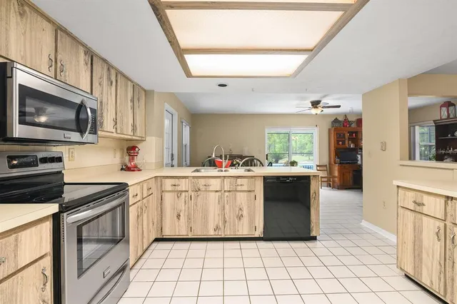 a kitchen with a stove a sink and a microwave