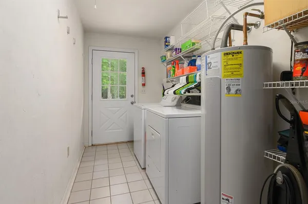 a utility room with fridge dryer and washer