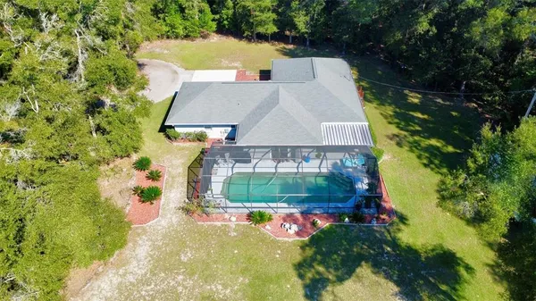 an aerial view of a house with garden space and street view