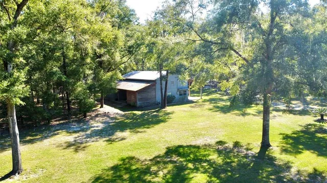 a backyard of a house with yard and outdoor seating
