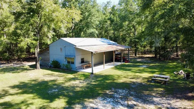 a view of a house with a yard porch and sitting area
