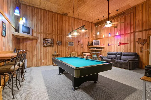 a room with pool table and windows
