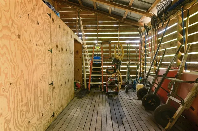 a view of a balcony with chairs and wooden floor