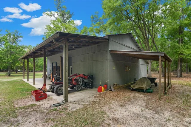 a view of a chair and table in backyard of the house