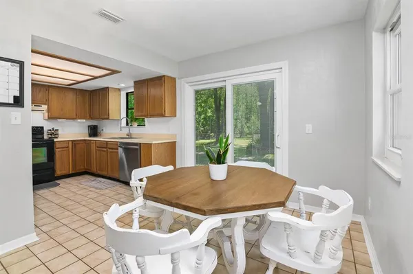 a kitchen with a table chairs and wooden floor
