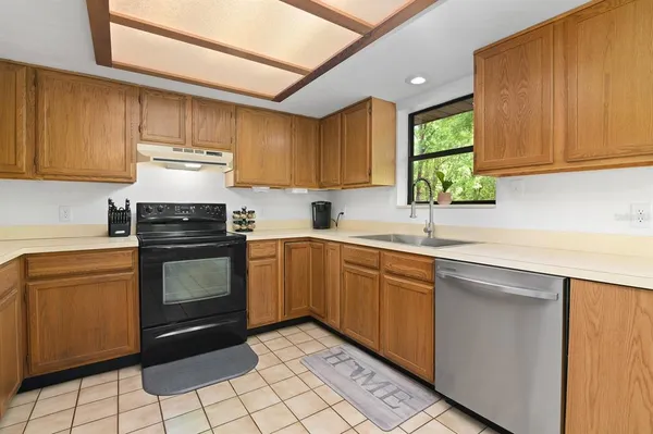 a kitchen with cabinets a sink and appliances