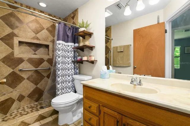 a bathroom with a sink toilet and shower