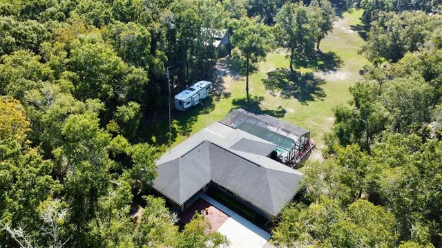 an aerial view of house with yard and outdoor seating