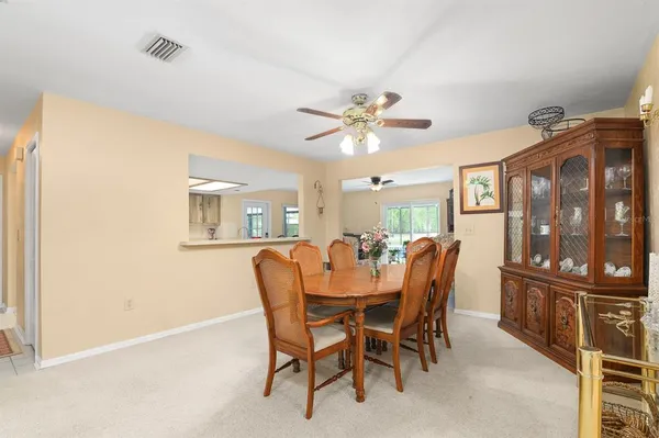 a view of a dining room with furniture and a chandelier