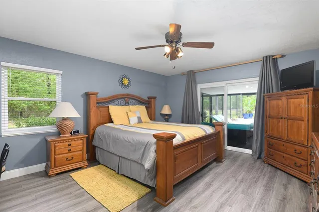a bedroom with a bed and a flat tv screen on dresser