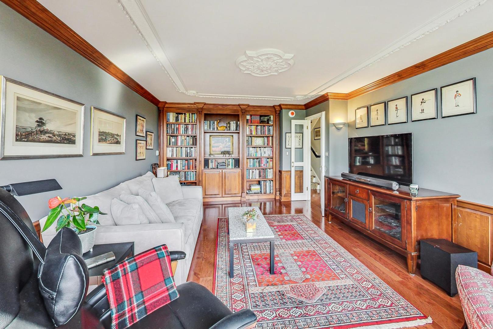 1630 Sheridan Road, Unit 8B Wilmette, IL 60091 - Photo 22 of 45 a living room with furniture and a flat screen tv
