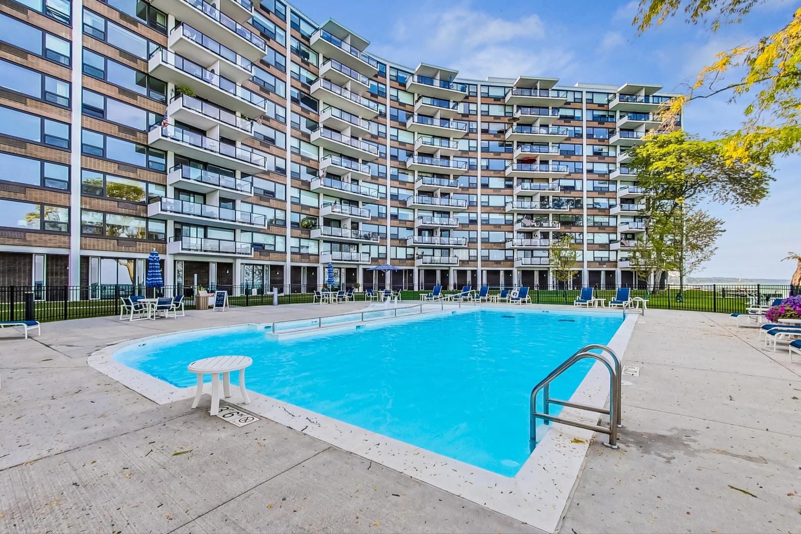 1630 Sheridan Road, Unit 8B Wilmette, IL 60091 - Photo 29 of 45 a view of a swimming pool with a lounge chair