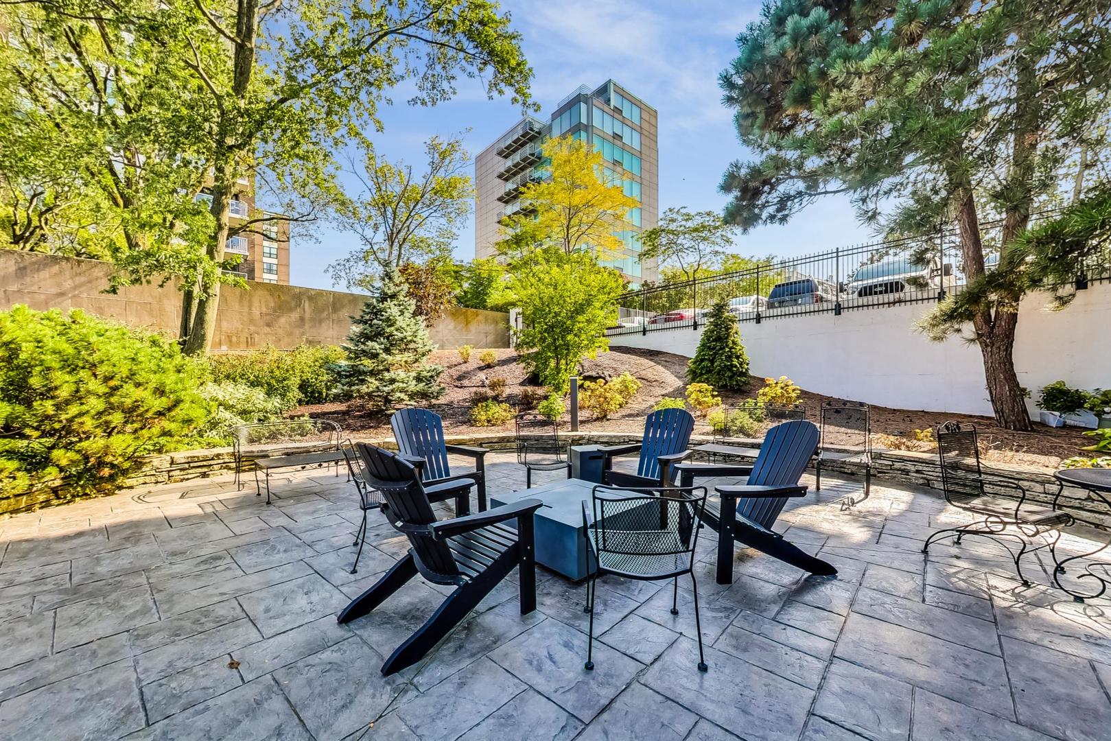1630 Sheridan Road, Unit 8B Wilmette, IL 60091 - Photo 33 of 45 a view of a chairs and table in a backyard