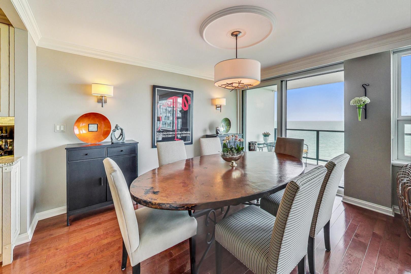 1630 Sheridan Road, Unit 8B Wilmette, IL 60091 - Photo 6 of 45 a view of a dining room with furniture wooden floor and chandelier