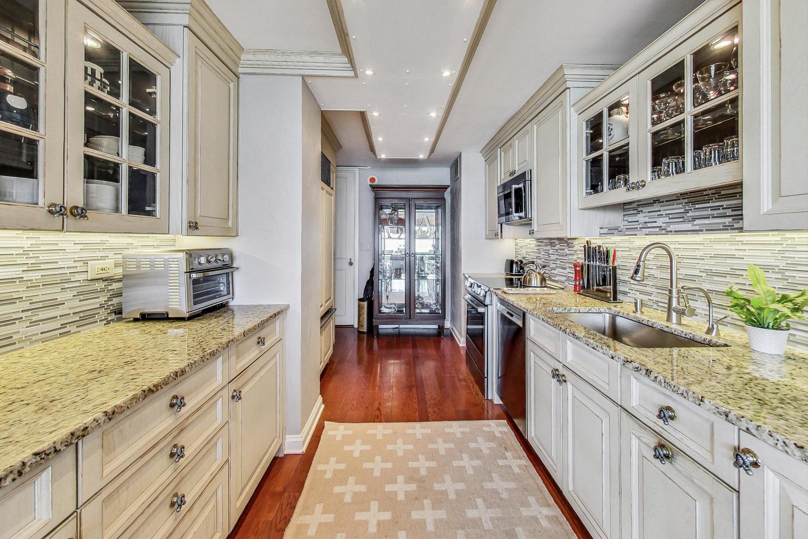 1630 Sheridan Road, Unit 8B Wilmette, IL 60091 - Photo 10 of 45 a kitchen with stainless steel appliances granite countertop a sink stove and cabinets