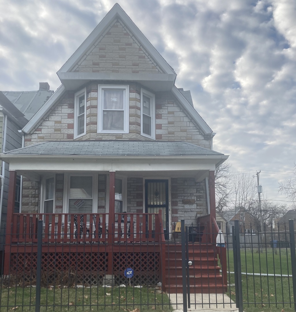 6528 South Sangamon Street Chicago, IL 60621 - Photo 1 of 6 a front view of a house with garden
