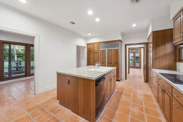 a kitchen with granite countertop a stove and a sink