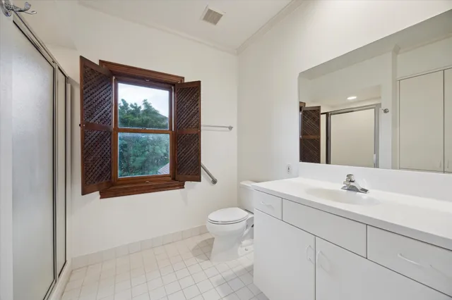 a bathroom with a sink toilet and mirror