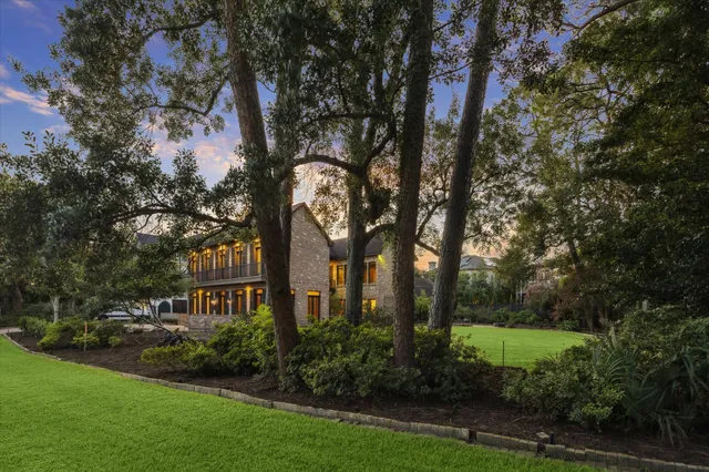 a view of a house with garden and trees