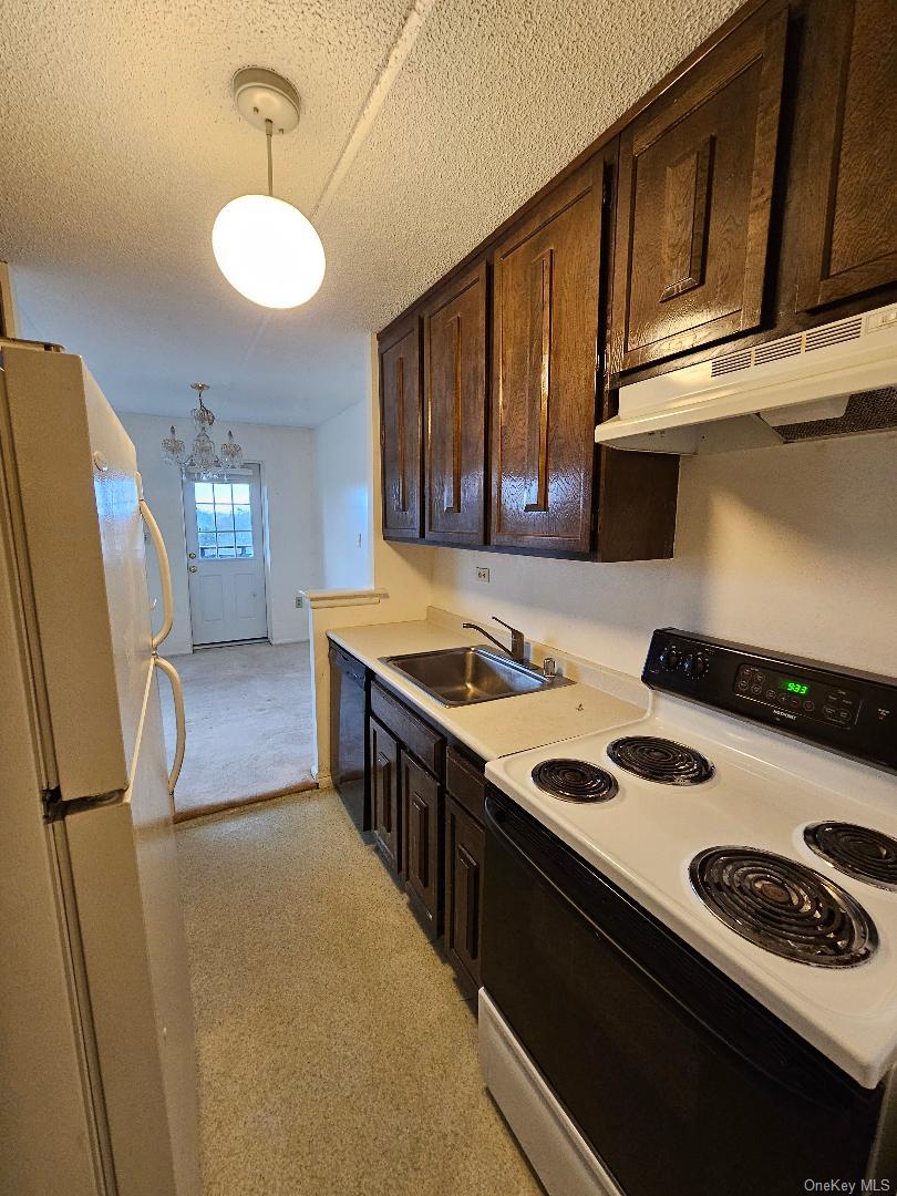 160 Academy Street, Unit 3N Poughkeepsie, NY 12601 - Photo 8 of 8 a kitchen that has a sink stainless steel appliances a counter space and a window
