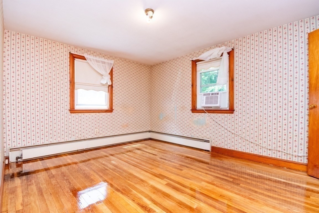 5 Edward Street Canton, MA 02021 - Photo 15 of 24 a view of an empty room with wooden floor and a window