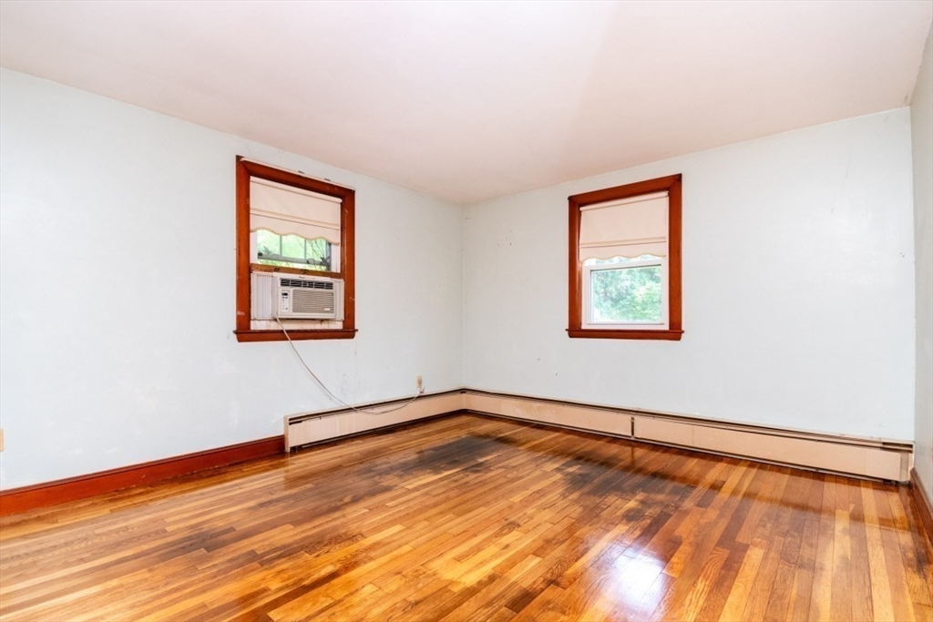 5 Edward Street Canton, MA 02021 - Photo 17 of 24 a view of an empty room with wooden floor and a window