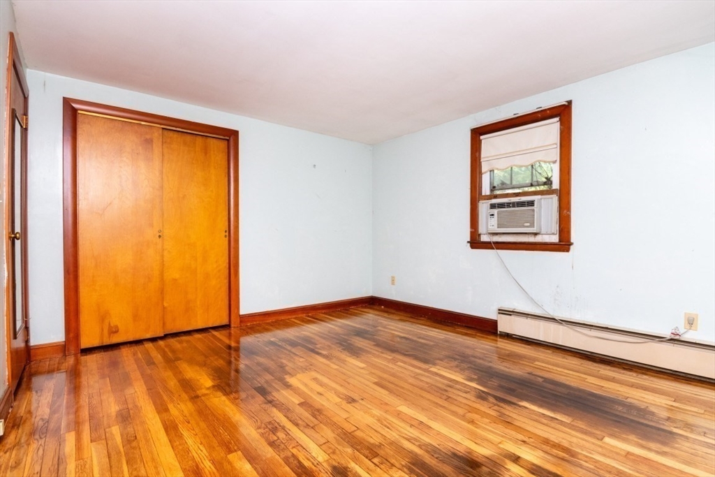 5 Edward Street Canton, MA 02021 - Photo 18 of 24 an empty room with wooden floor and a window