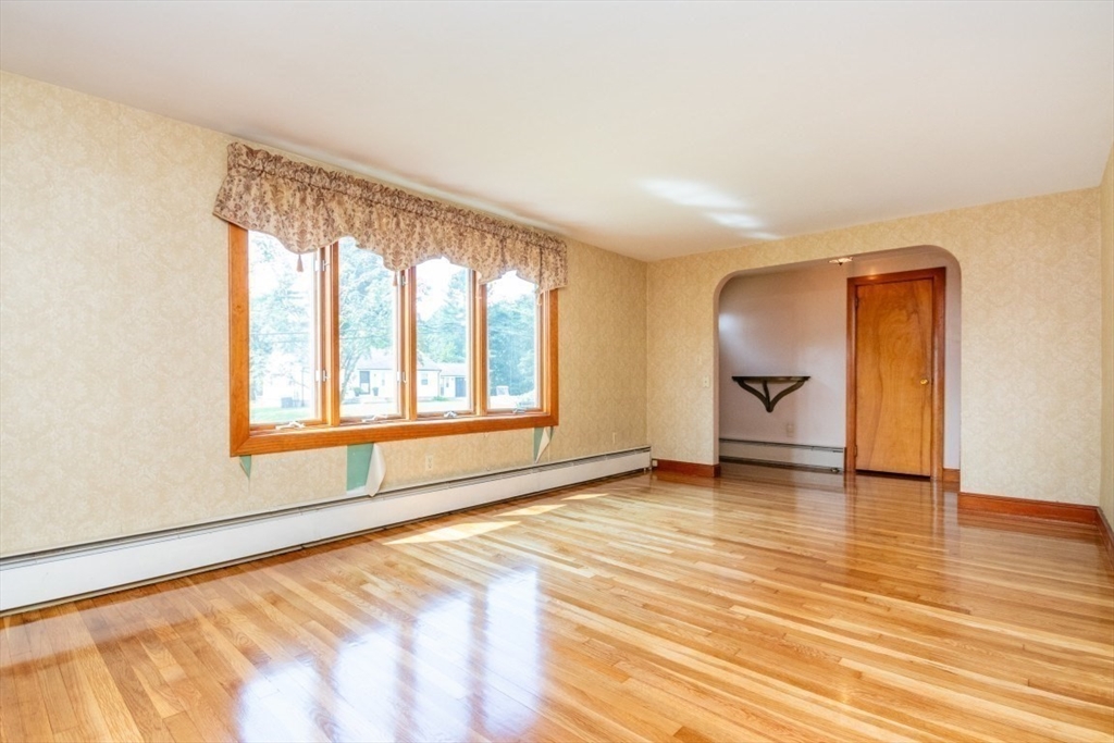5 Edward Street Canton, MA 02021 - Photo 4 of 24 a view of an empty room with a window and wooden floor