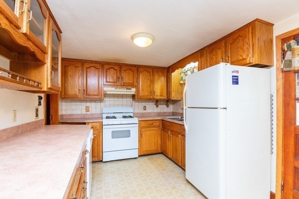5 Edward Street Canton, MA 02021 - Photo 9 of 24 a kitchen with a refrigerator a stove a sink and dishwasher