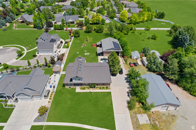 580 North 300 East Logan, UT 84321 - Photo 5 of 74 Expansive property featuring a large primary residence, a detached secondary structure with a gray roof, and substantial green space