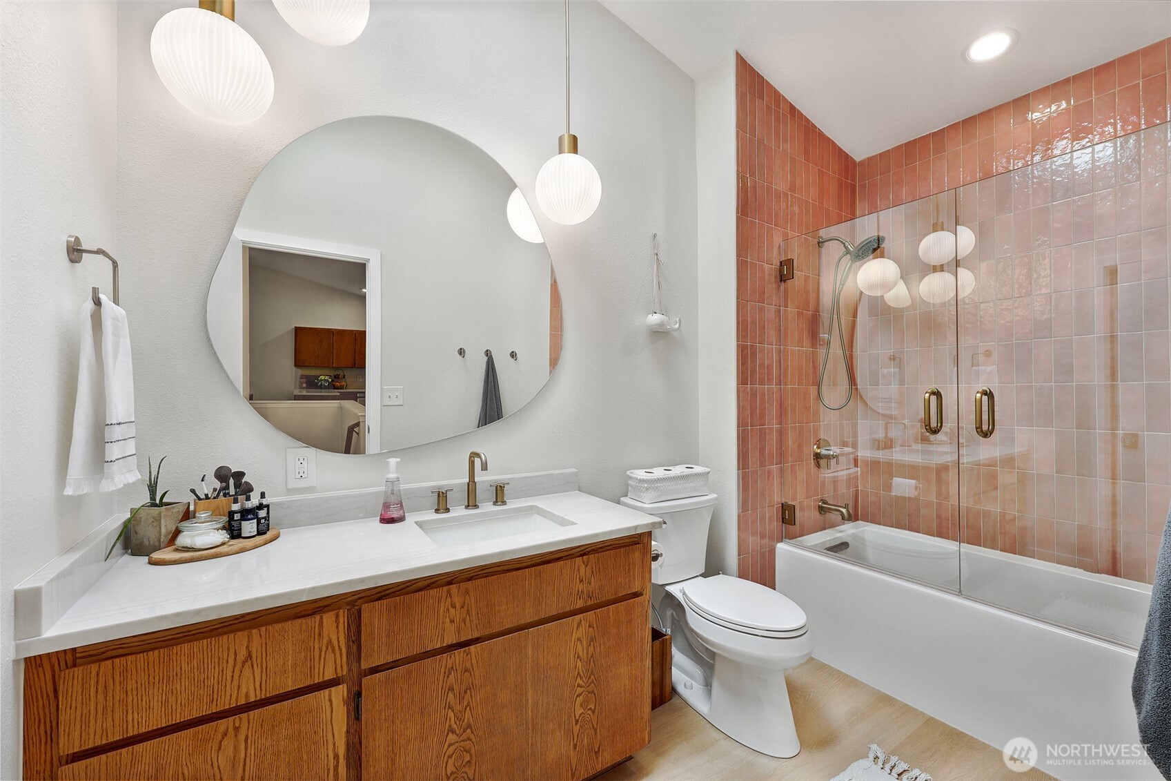 5126 South Garden Loop Road, Unit 11 Seattle, WA 98118 - Photo 18 of 36 a bathroom with a toilet a sink a tub and mirror