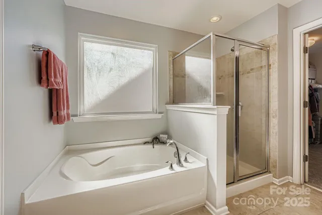 a bathroom with a bathtub and a shower