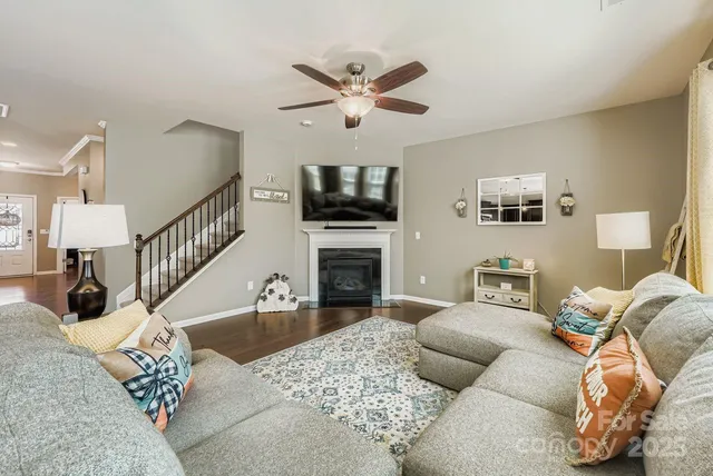 a living room with furniture a fireplace and a flat screen tv