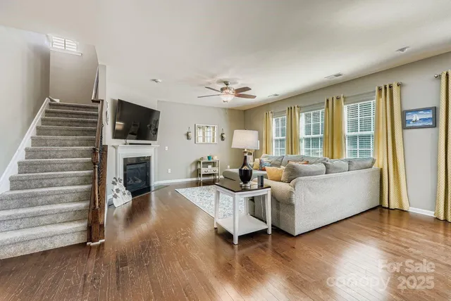 a living room with furniture a fireplace and a flat screen tv
