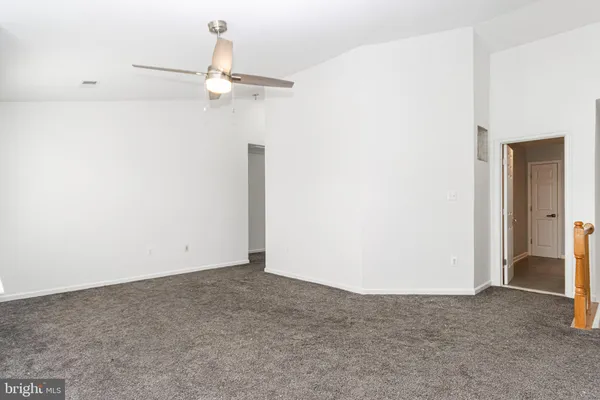 a view of a room with a ceiling fan and closet