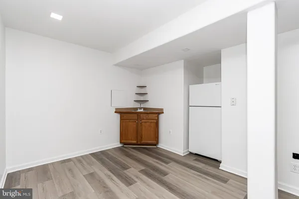 a view of a kitchen with a sink and a refrigerator