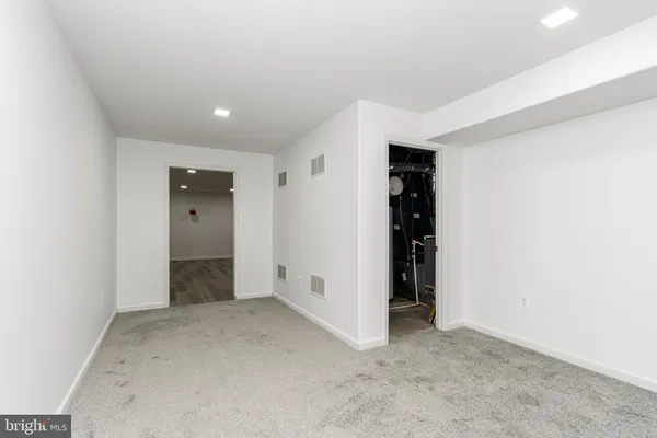 an empty room with closet and natural light
