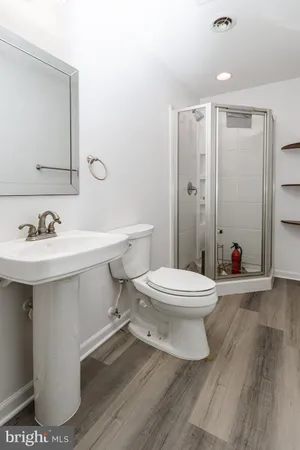 a bathroom with a sink toilet and shower