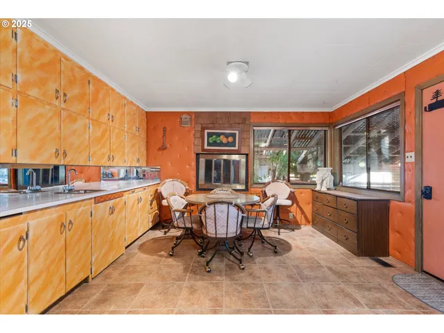 a living room with furniture a large window and a sink