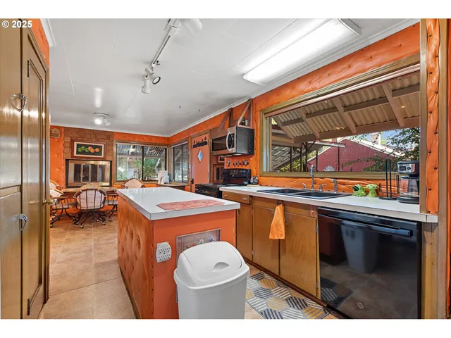 a open kitchen with stainless steel appliances granite countertop a stove a sink and a refrigerator