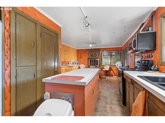 a kitchen with stainless steel appliances granite countertop a sink a stove and a refrigerator