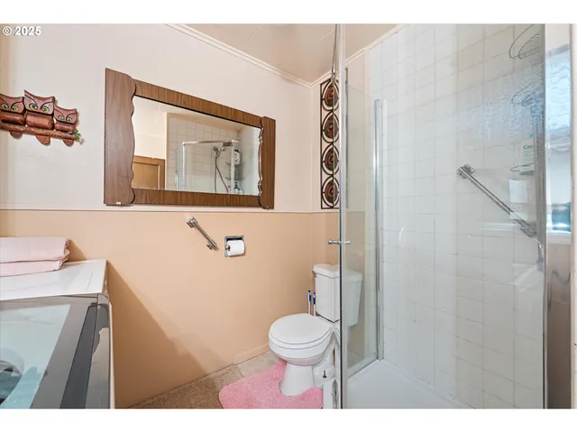 a bathroom with a toilet sink and mirror